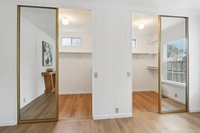 a bed room with a bed and a chair