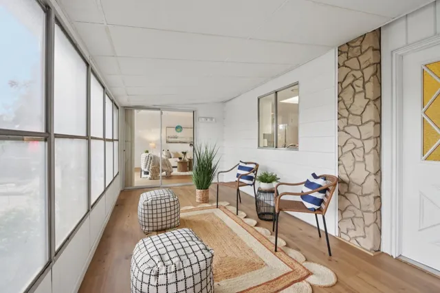 a view of a backyard with sitting area and garden