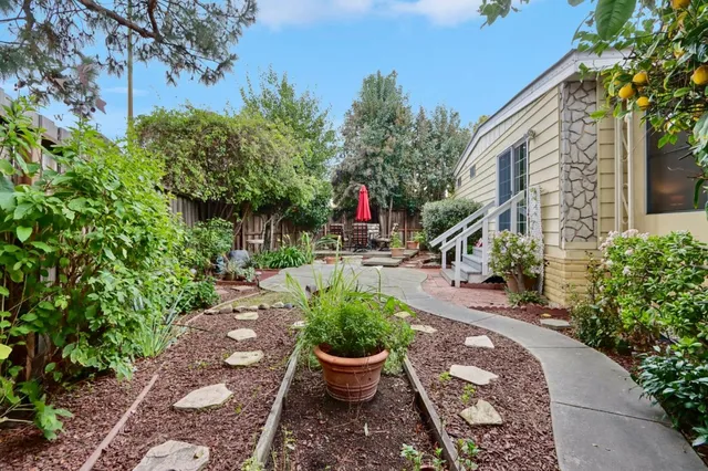 a view of a backyard with sitting area and slide
