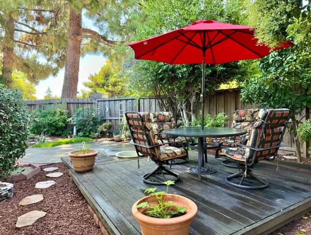 a view of a backyard with plants and a patio