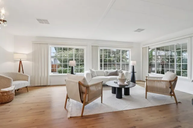 a living room with furniture and large windows