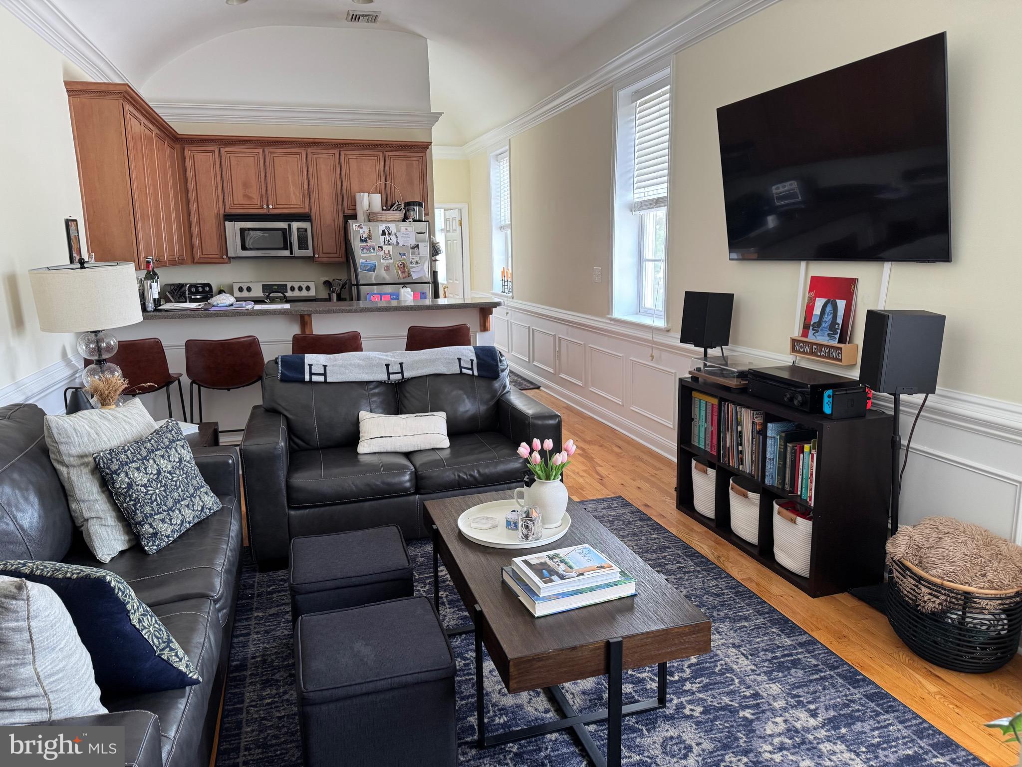 1 Kings Court, Unit 5 Haddonfield, NJ 08033 - Photo 3 of 15 a living room with furniture and a flat screen tv