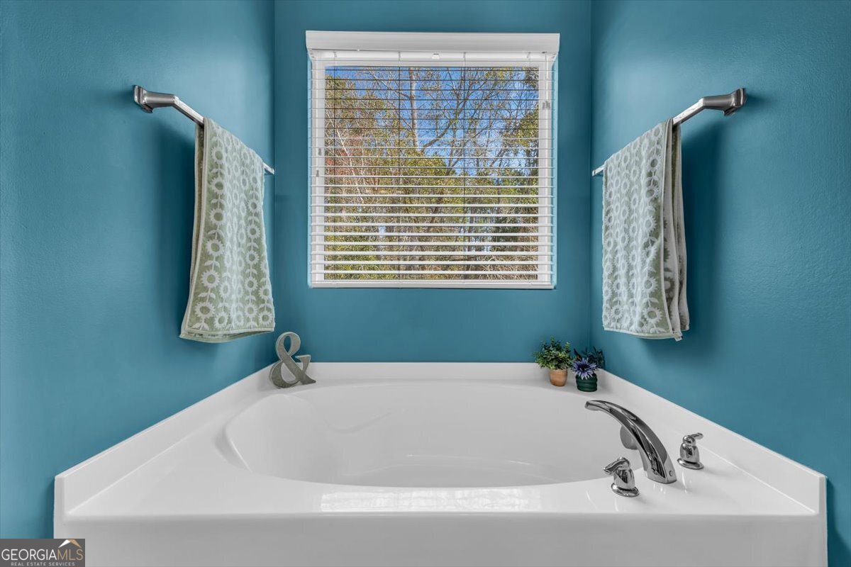 2 Crestview Circle Pooler, GA 31322 - Photo 28 of 55 a white bath tub sitting in a bathroom next to a window