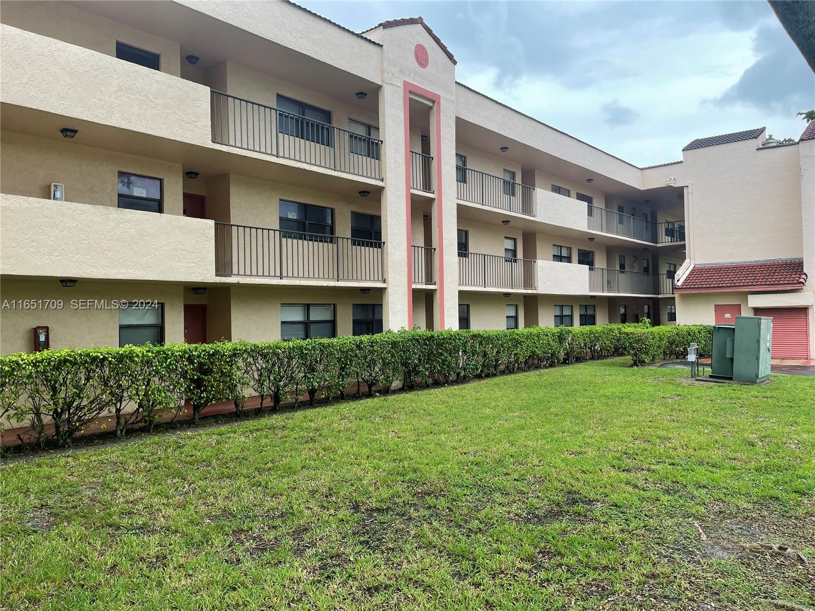 3252 Foxcroft Road, Unit 206 Miramar, FL 33025 - Photo 1 of 10 a front view of a building
