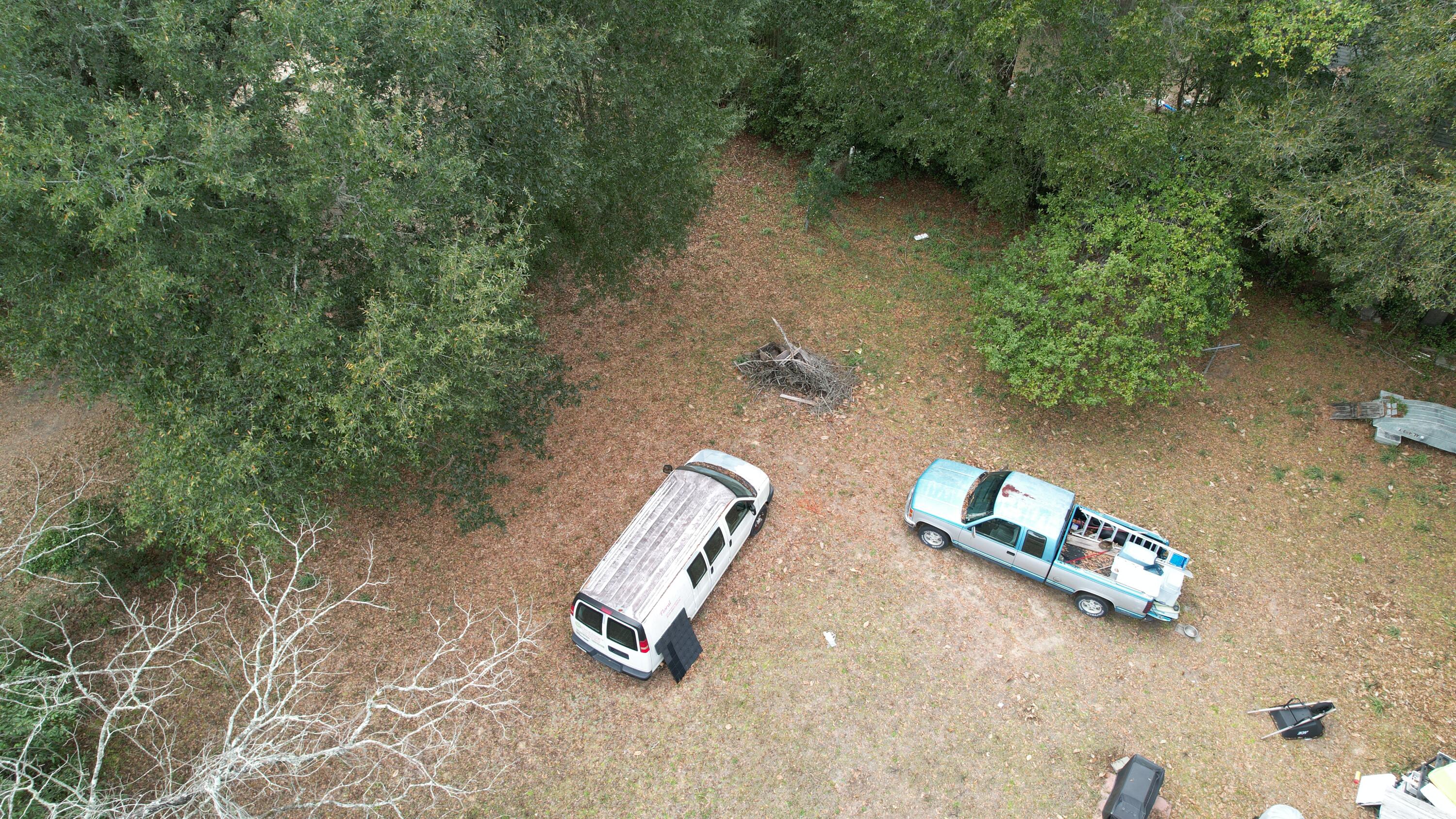 625 East Chestnut Avenue Crestview, FL 32539 - Photo 12 of 19 an aerial view of a lake with a yard