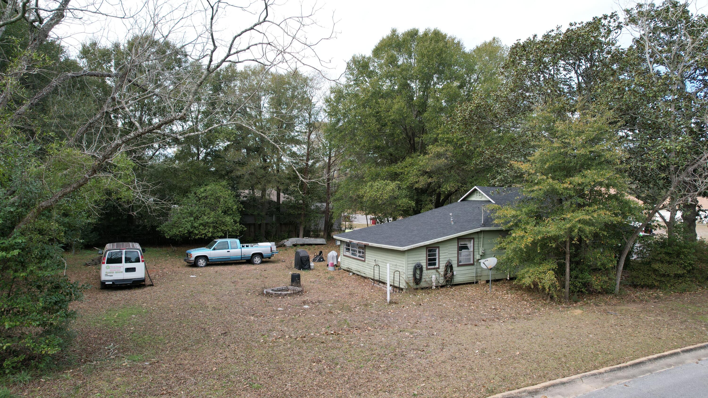 625 East Chestnut Avenue Crestview, FL 32539 - Photo 17 of 19 a view of a couches and a table and chairs in the patio