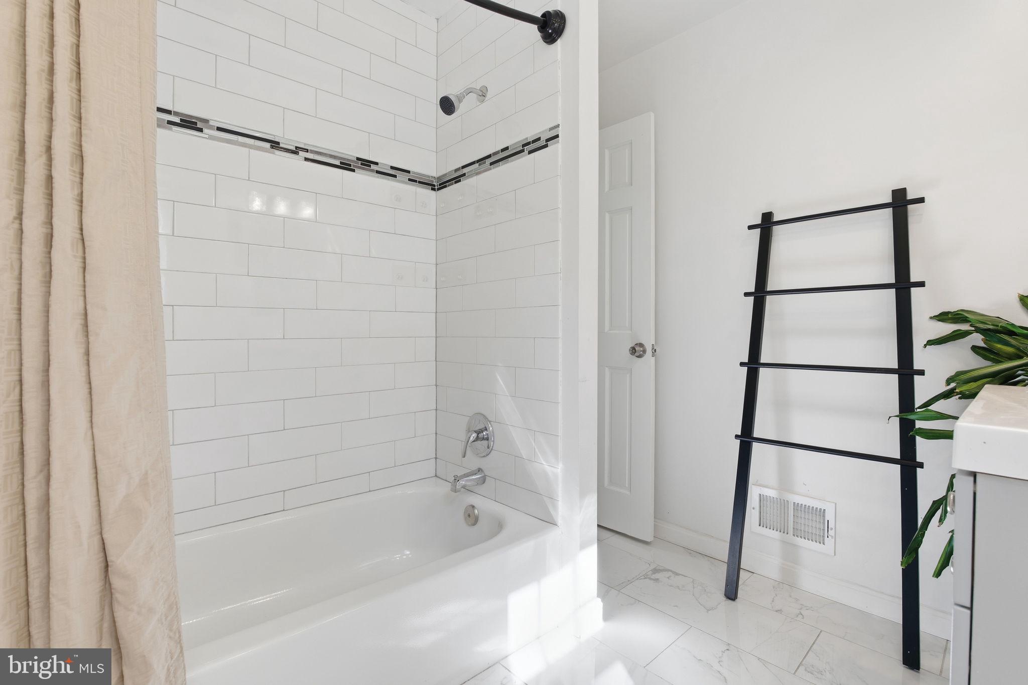 15101 Redgate Drive Silver Spring, MD 20905 - Photo 33 of 39 a bathroom with a bathtub and shower