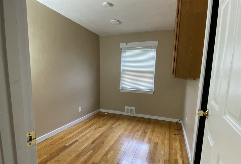 118 Spruce Road Norwood, MA 02062 - Photo 5 of 39 a view of a room with wooden floor and a window