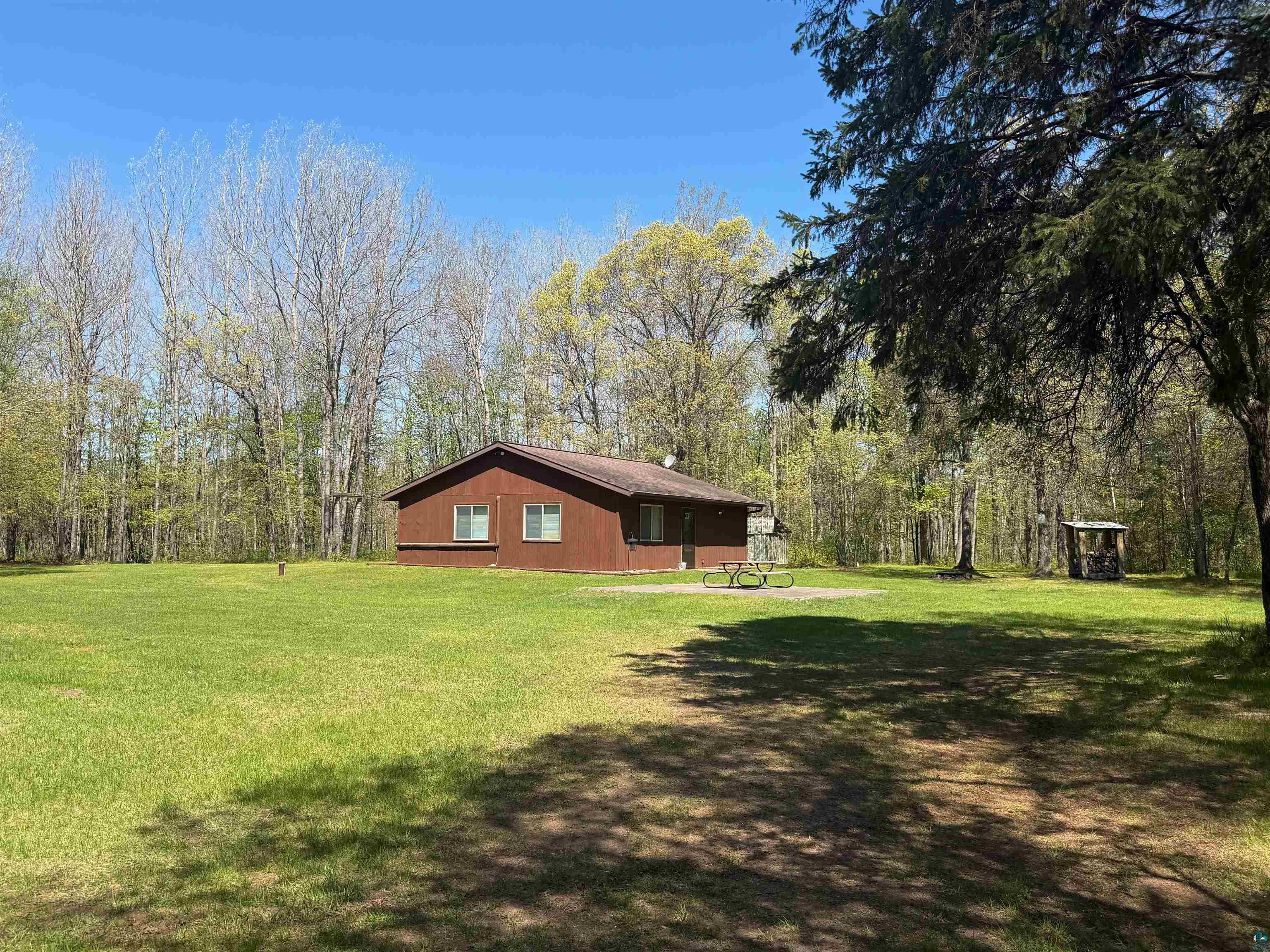 12235 East Crooked Lake Road Gordon, WI 54838 - Photo 2 of 48 Brown-sided residence set on a large, open grassy area