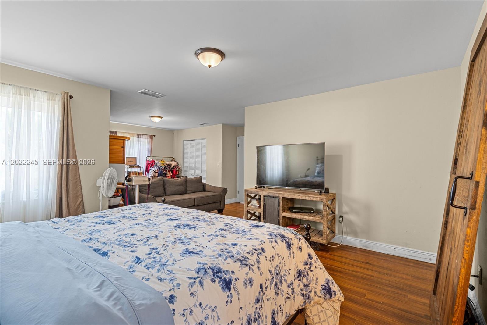 15530 Southwest 59th Street Miami, FL 33193 - Photo 27 of 58 a bed room with a bed and a flat screen tv