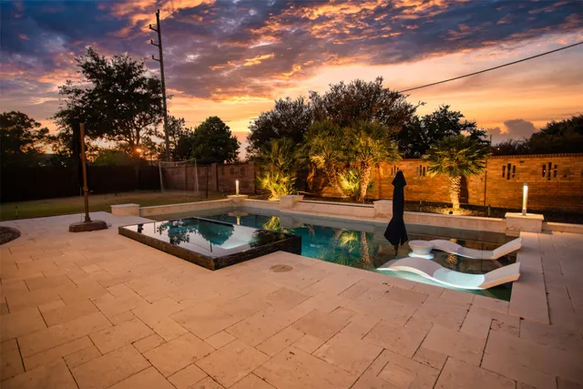 a view of a patio with swimming pool