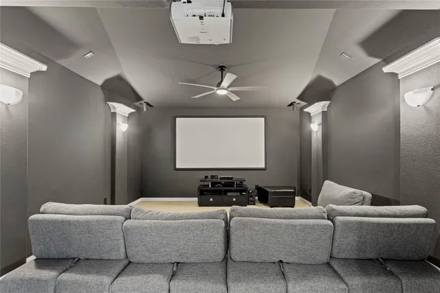 a living room with furniture a ceiling fan and a rug