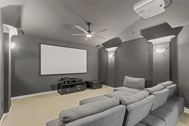 a living room with furniture a projector and screen