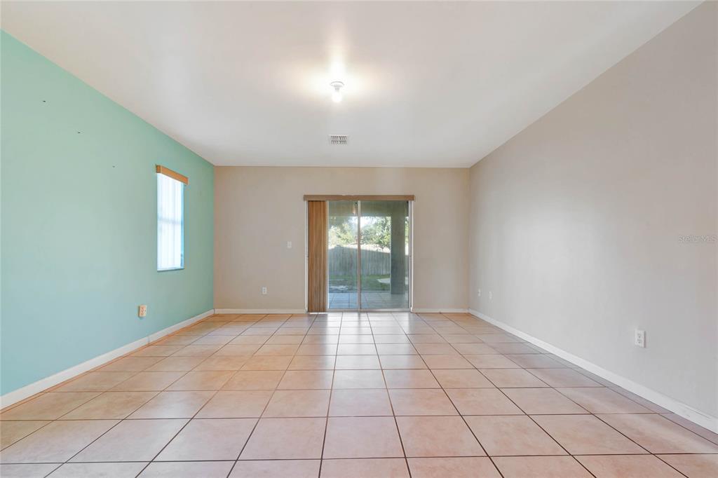 2443 Waterfall Drive Spring Hill, FL 34608 - Photo 25 of 35 a view of an empty room with window and wooden floor