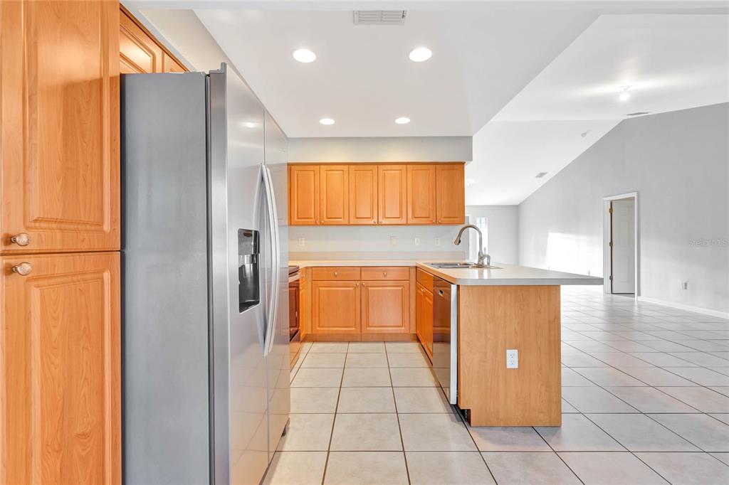 2443 Waterfall Drive Spring Hill, FL 34608 - Photo 7 of 35 a kitchen with granite countertop a sink a counter top space and stainless steel appliances