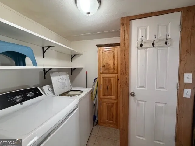 a utility room with closet dryer and washer