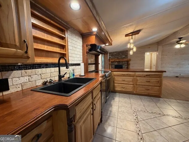 a kitchen that has a sink and a stove