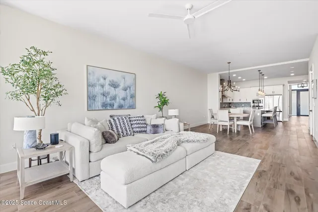 a kitchen with stainless steel appliances granite countertop a sink a stove and a wooden floors