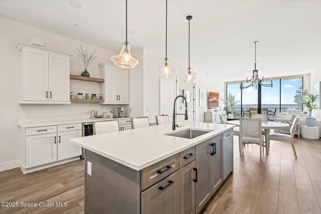 a kitchen with stainless steel appliances granite countertop a stove a sink and white cabinets
