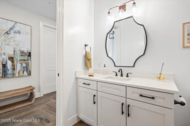 a bathroom with a double vanity sink mirror and toilet