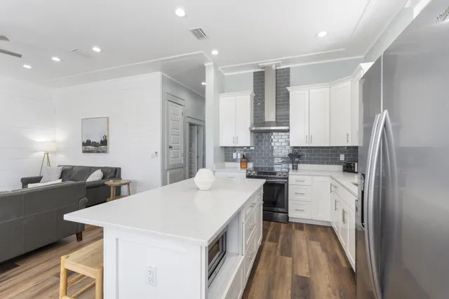 a kitchen with white cabinets and white appliances