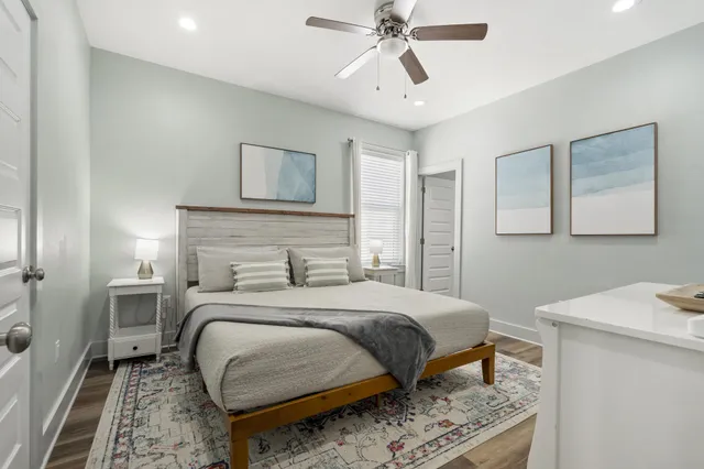 a bedroom with a bed and a chandelier