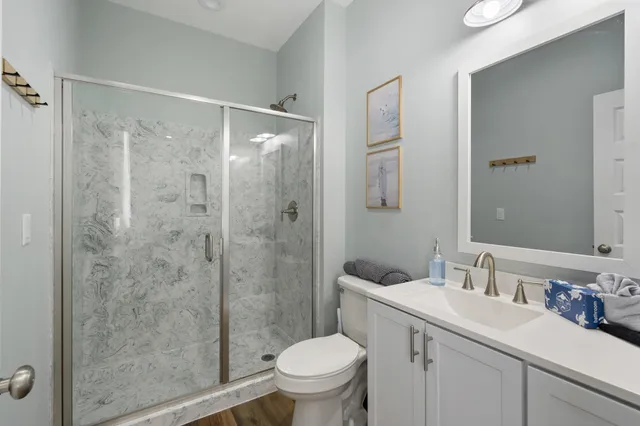 a bathroom with a sink toilet and shower