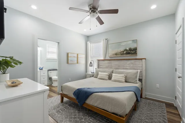 a bedroom with a large bed and a chandelier