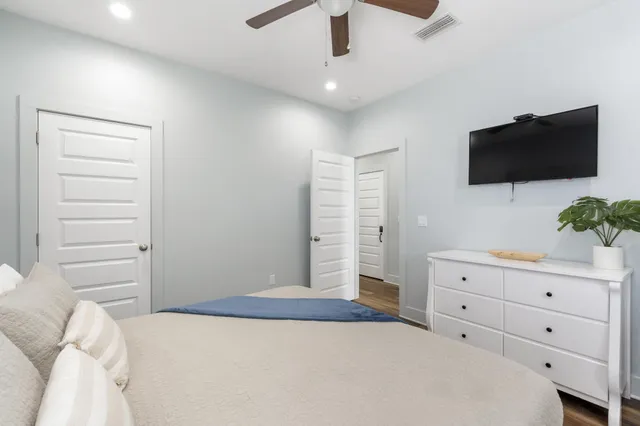 a bedroom with a bed and a flat screen tv