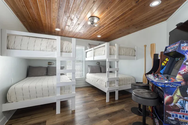 a bedroom with furniture and wooden floor