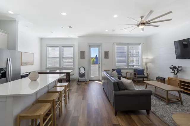 a living room with furniture a window and a flat screen tv