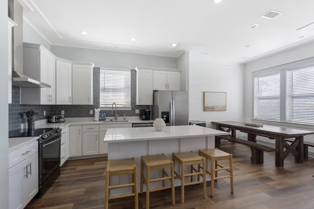 a large kitchen with a table and chairs