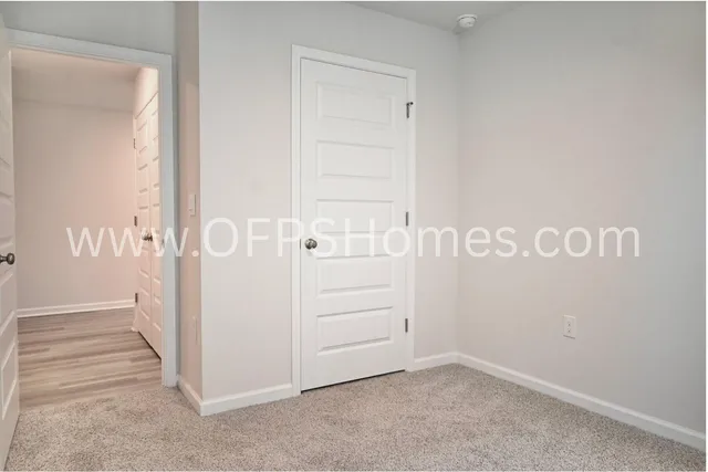 a room with kitchen island a sink and a stove with wooden floor