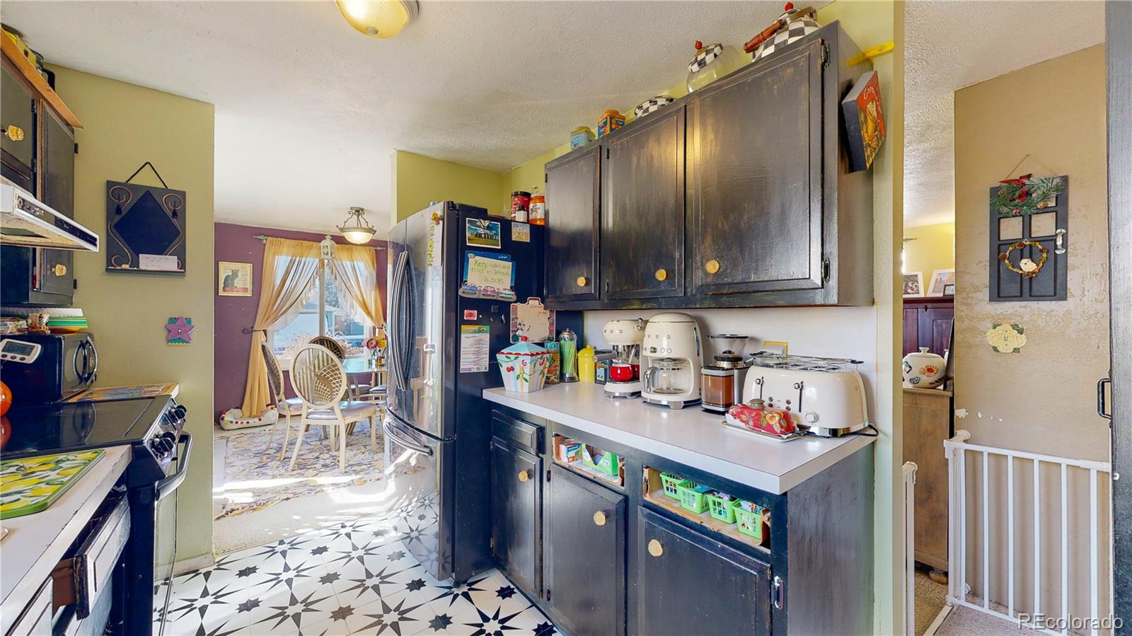 708 Independence Drive Longmont, CO 80504 - Photo 13 of 40 a kitchen with stainless steel appliances granite countertop a refrigerator and a wooden cabinets