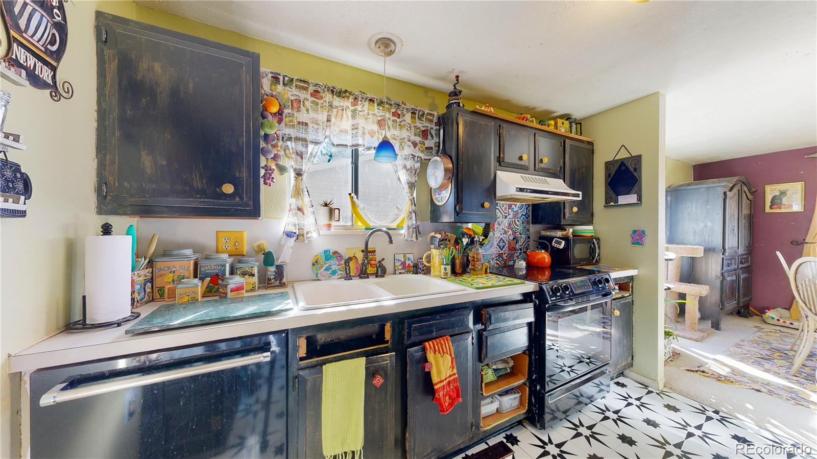 708 Independence Drive Longmont, CO 80504 - Photo 14 of 40 a utility room with stainless steel appliances lots of clutter and cabinets