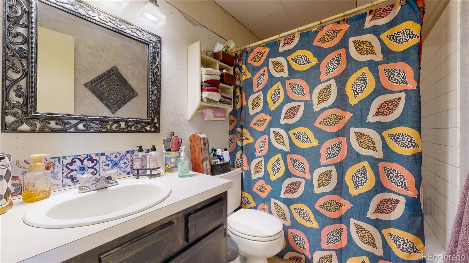708 Independence Drive Longmont, CO 80504 - Photo 15 of 40 a bathroom with a sink and mirror with toilet