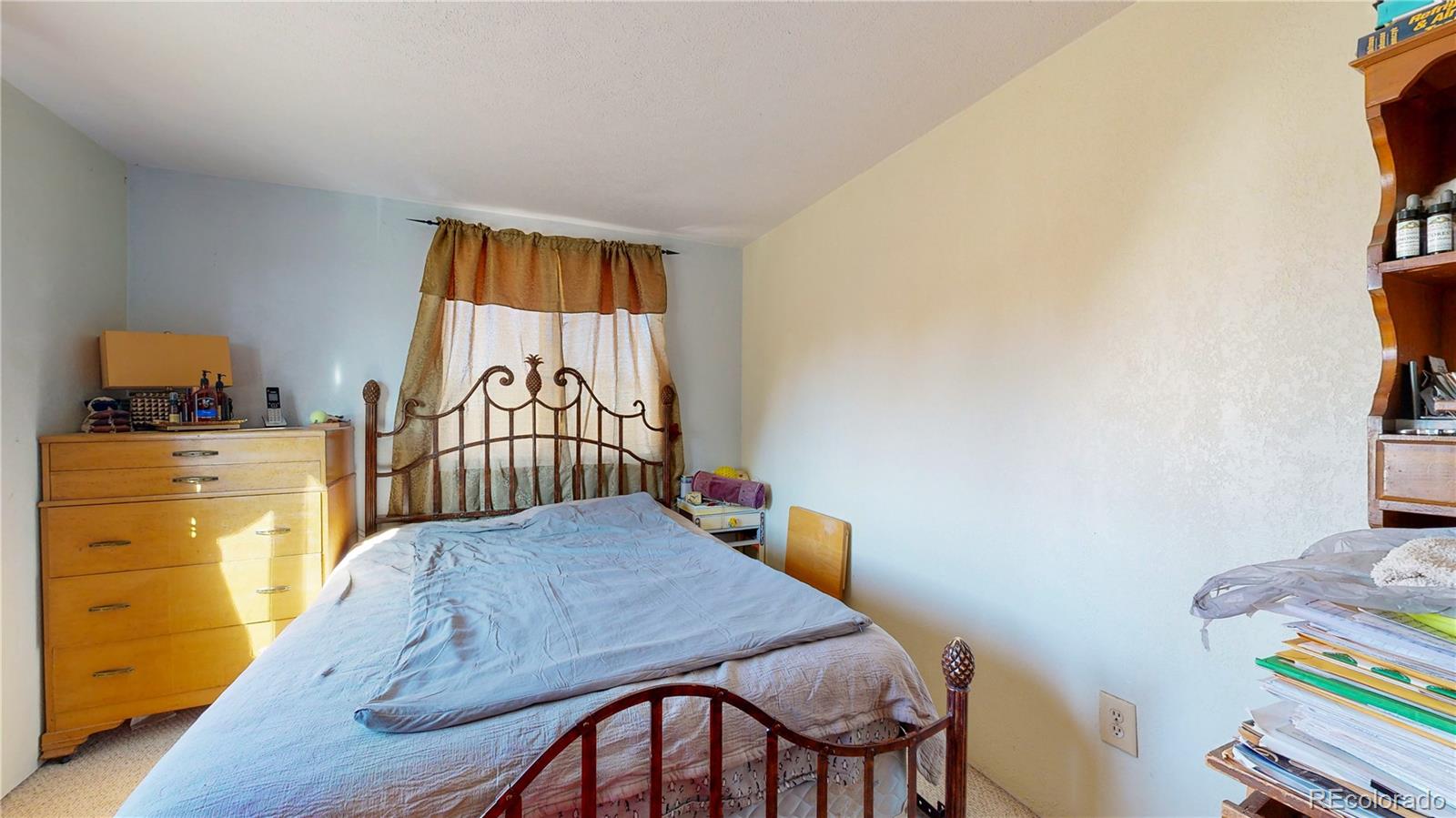 708 Independence Drive Longmont, CO 80504 - Photo 19 of 40 a bedroom with a bed and teddy bear on bed