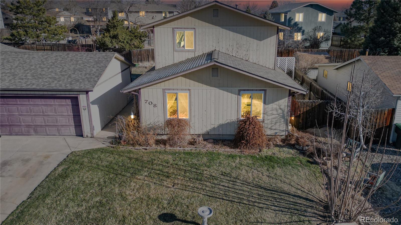 708 Independence Drive Longmont, CO 80504 - Photo 2 of 40 a front view of a house with garden