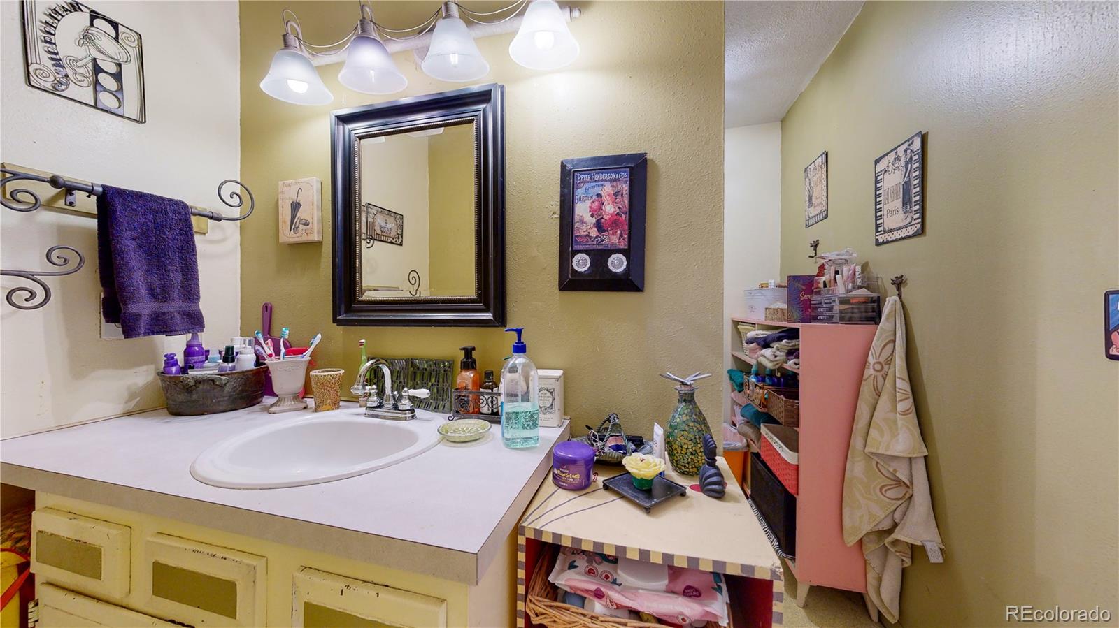 708 Independence Drive Longmont, CO 80504 - Photo 24 of 40 a bathroom with a sink mirror and vanity