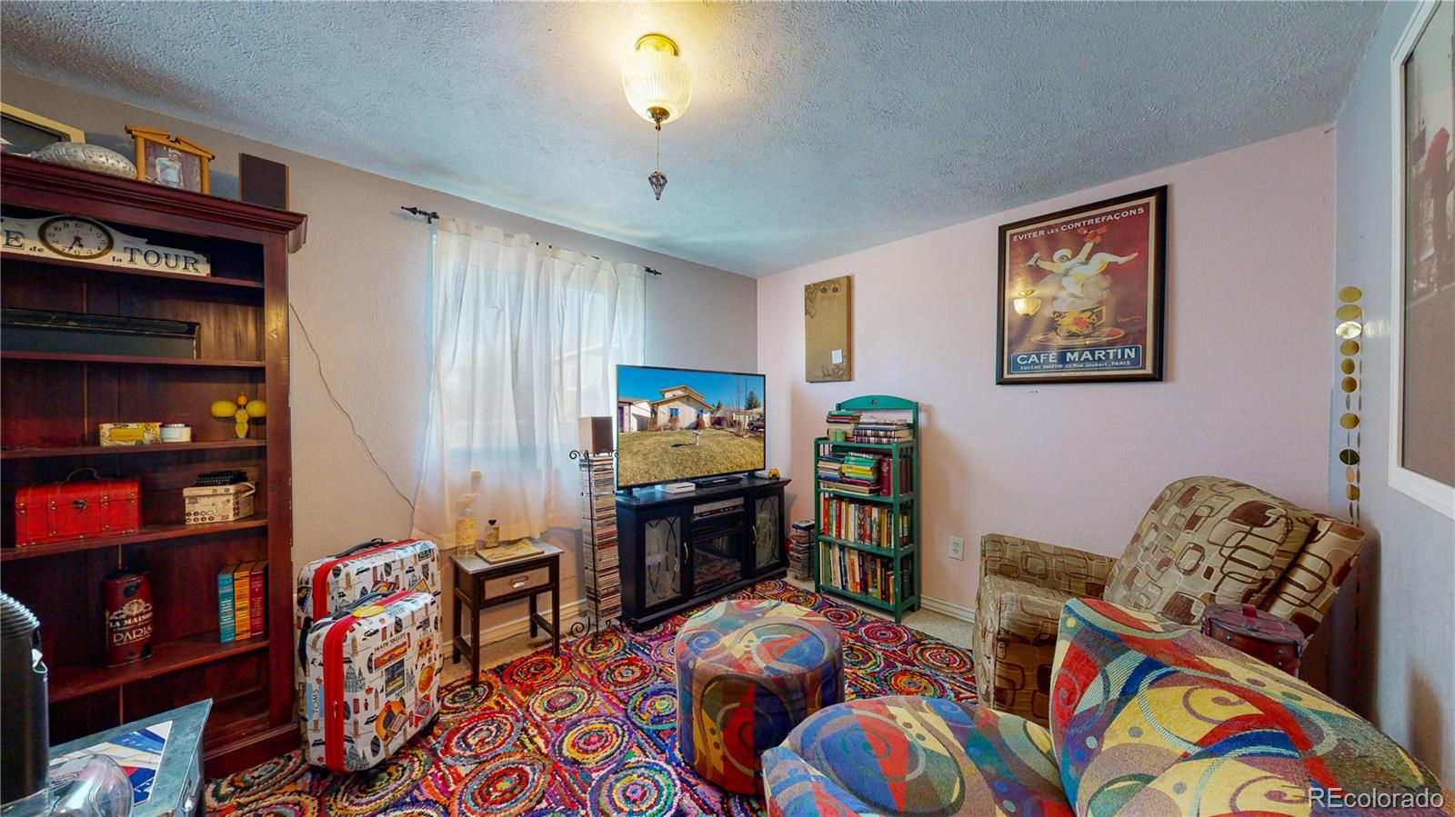 708 Independence Drive Longmont, CO 80504 - Photo 25 of 40 a bedroom with furniture and a book shelf