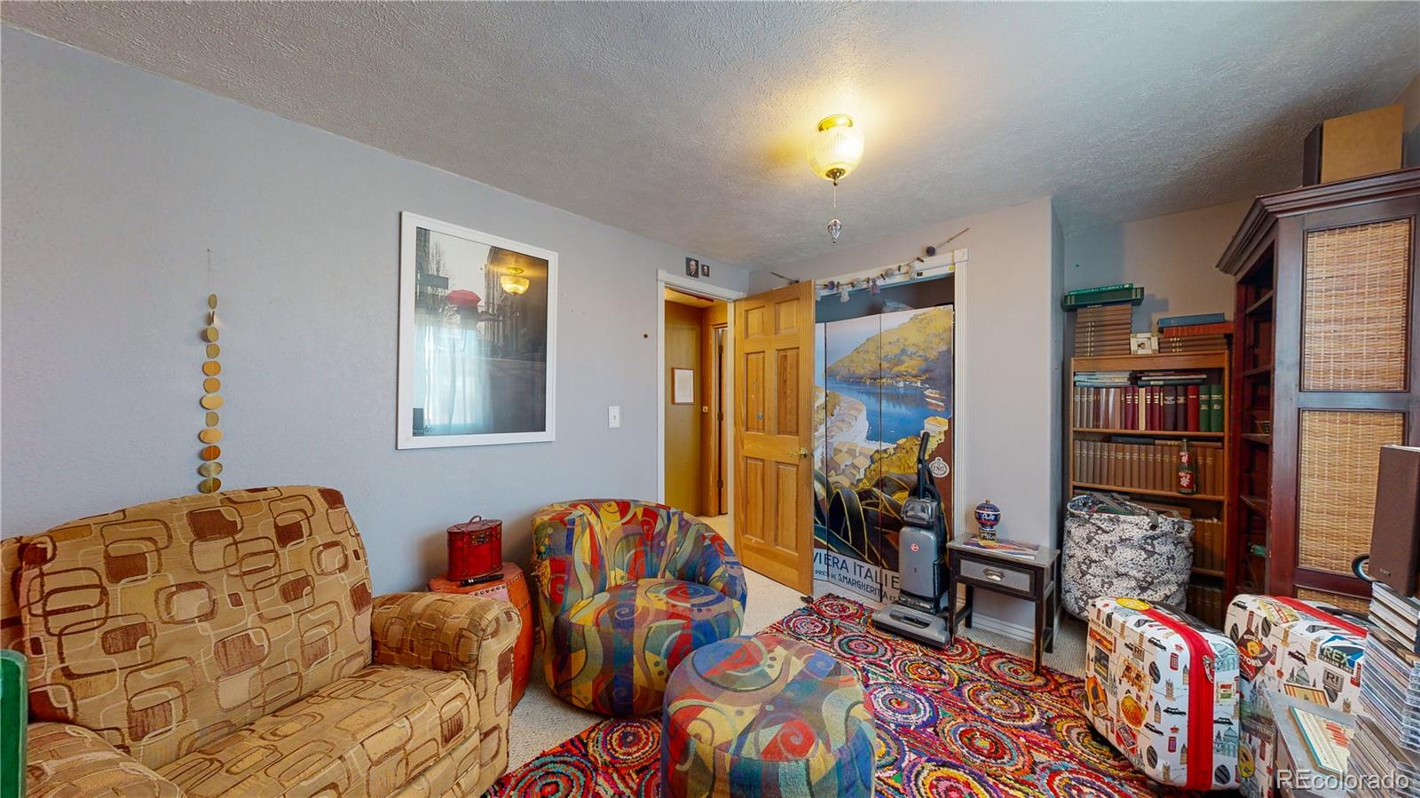 708 Independence Drive Longmont, CO 80504 - Photo 27 of 40 a bedroom with furniture and a book shelf