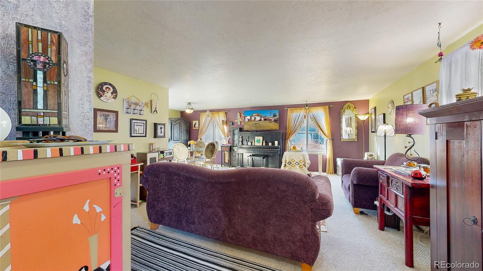 708 Independence Drive Longmont, CO 80504 - Photo 4 of 40 a living room with furniture a large window and bookshelf