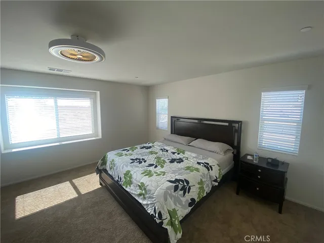 a spacious bathroom with a double vanity sink and mirror