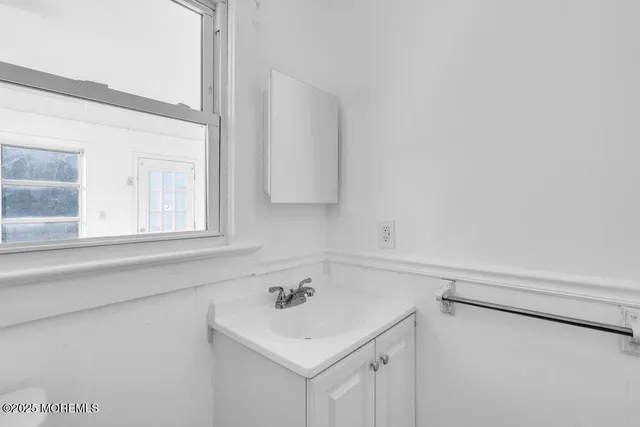 a bathroom with a sink and a window