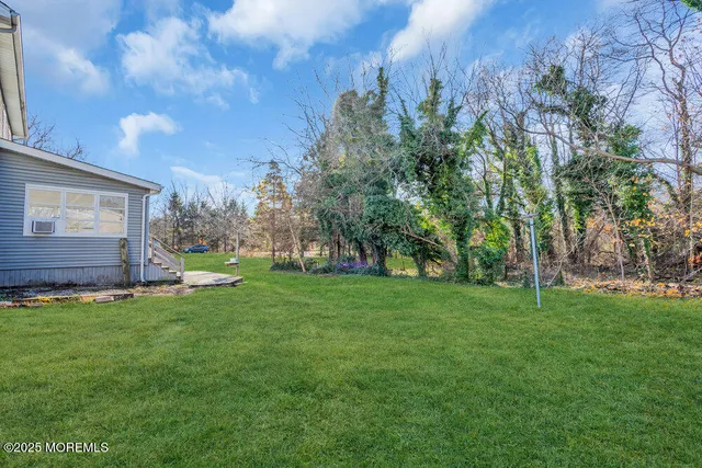 a view of a backyard with large trees