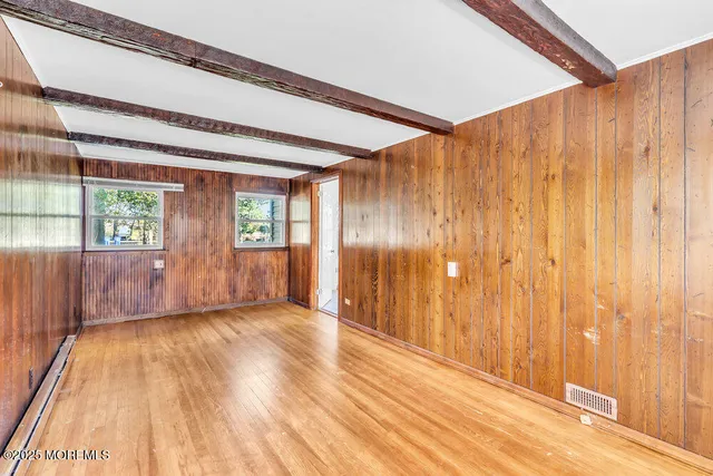 a view of wooden floor and windows in a room