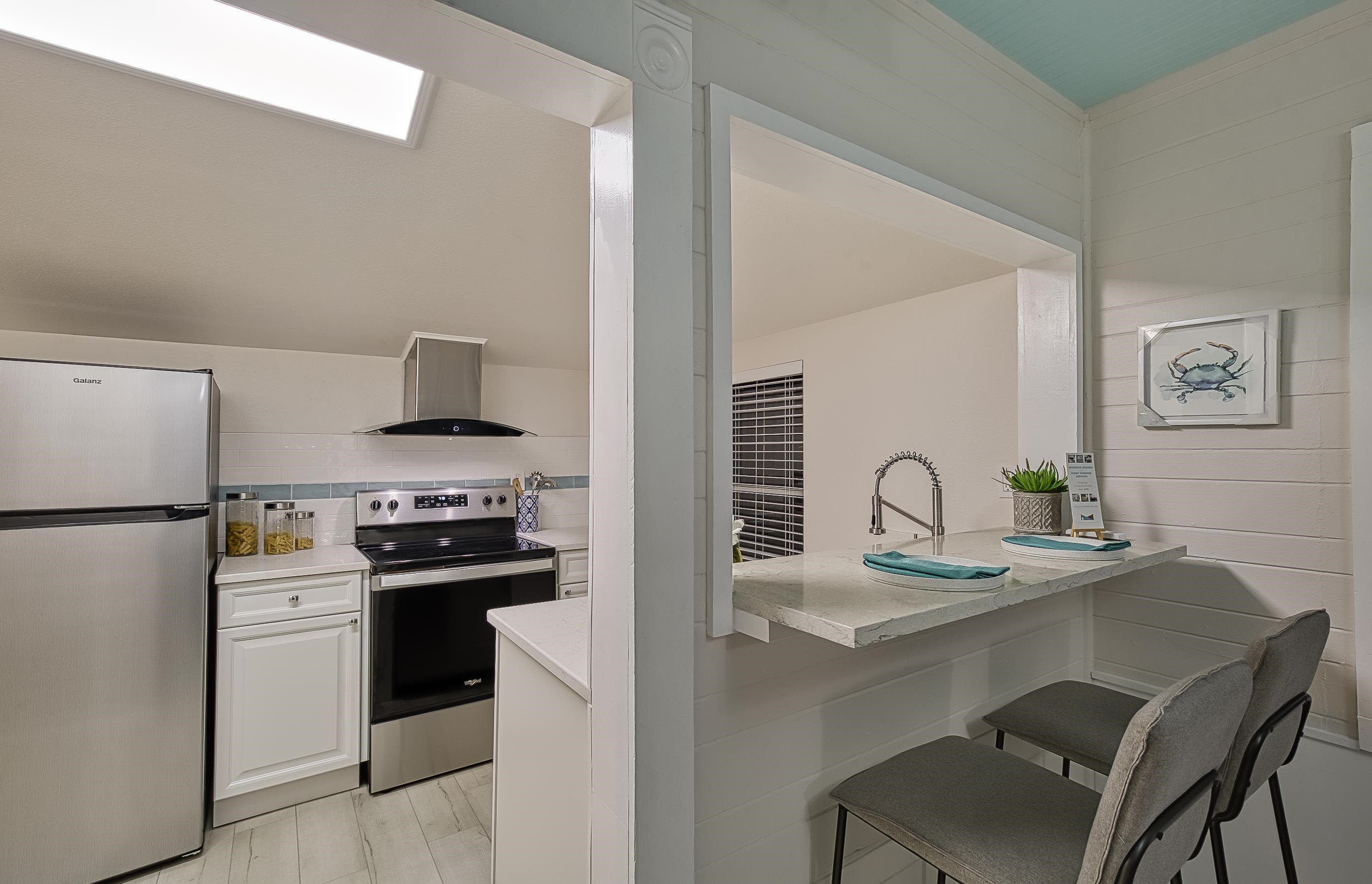 37 Phillips Street St. Augustine, FL 32084 - Photo 14 of 26 a kitchen with stainless steel appliances granite countertop a sink stove and refrigerator