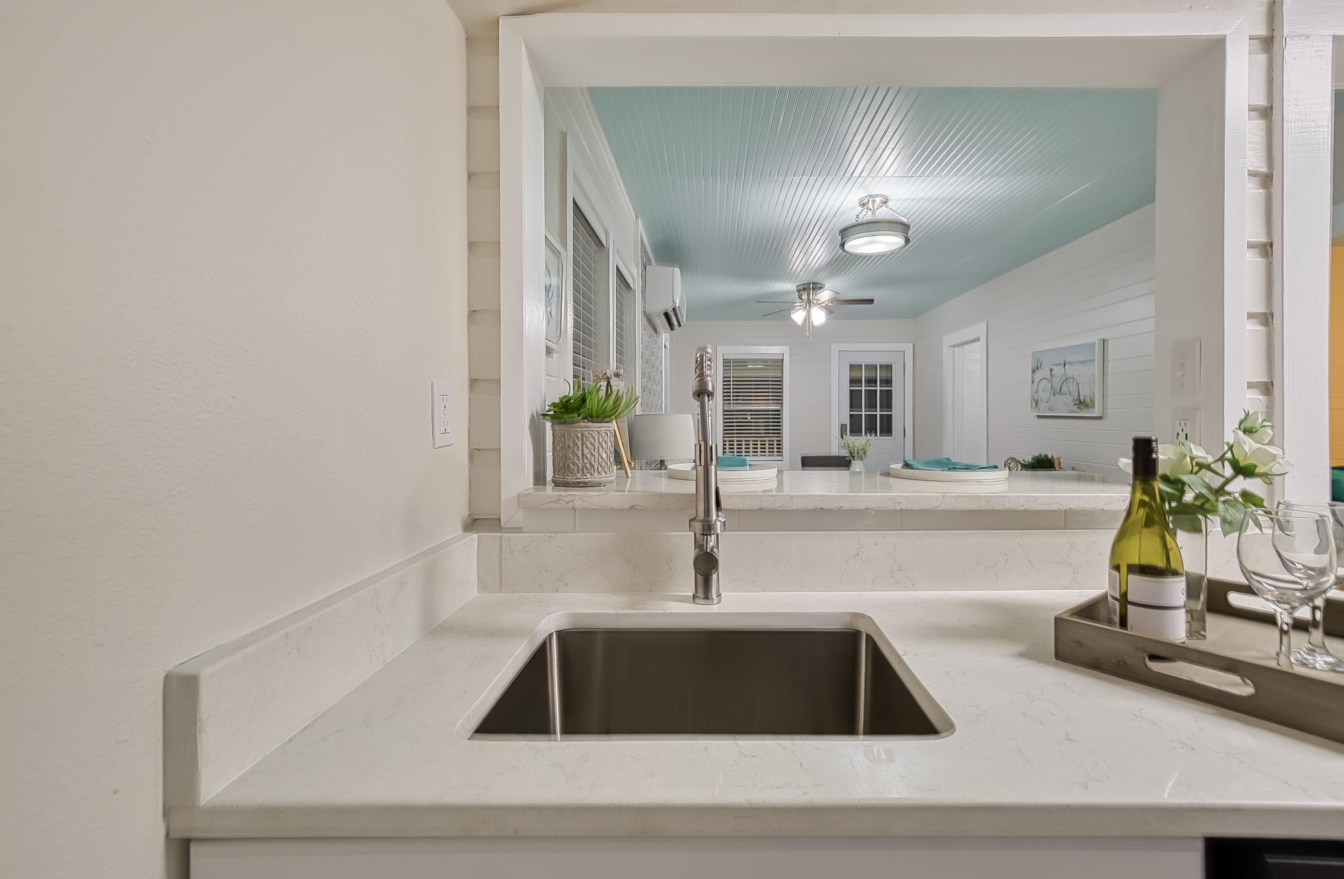 37 Phillips Street St. Augustine, FL 32084 - Photo 19 of 26 a kitchen with white cabinets and chandelier