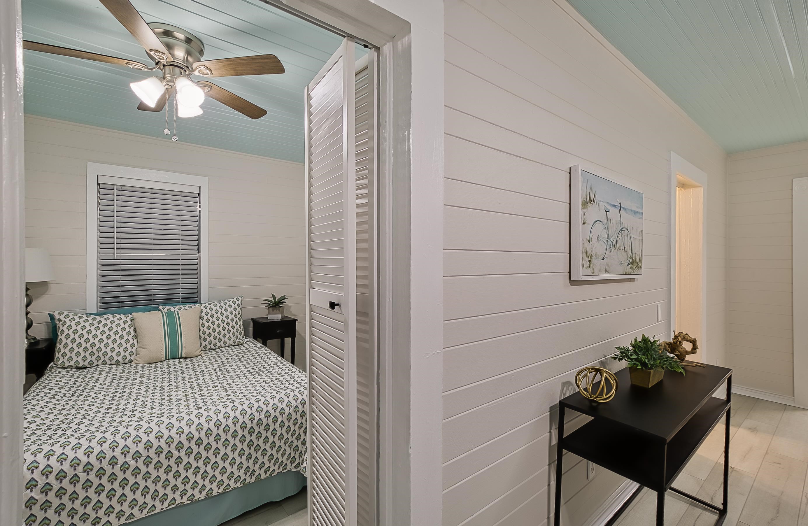 37 Phillips Street St. Augustine, FL 32084 - Photo 8 of 26 a bedroom with a bed and a table in it