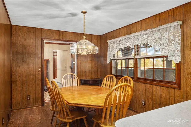 a view of a dining room with furniture chandelier and wooden floor